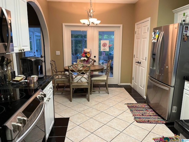 dining room with light tile patterned floors and a chandelier