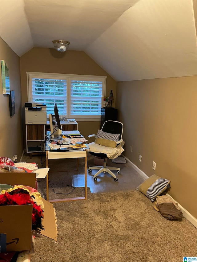 carpeted office space featuring lofted ceiling