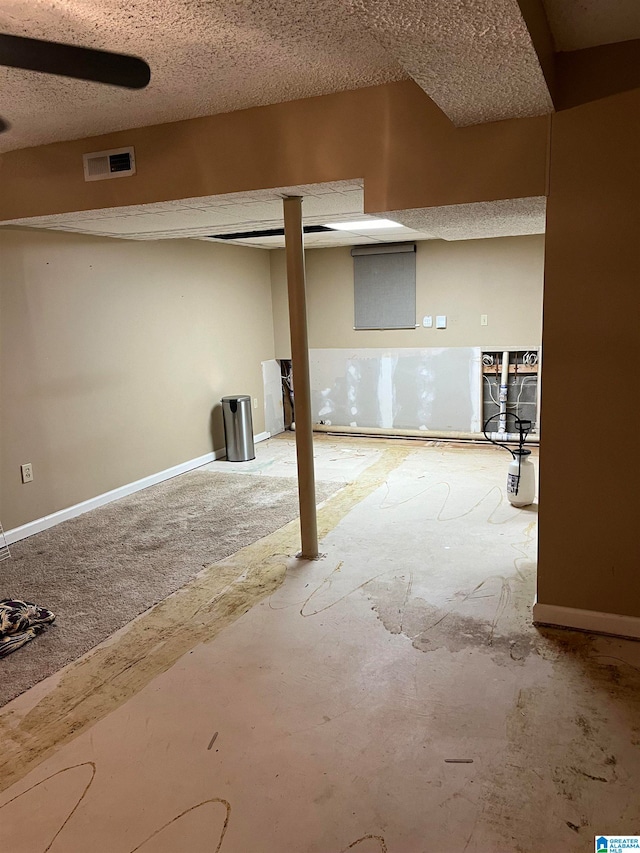 basement featuring a textured ceiling