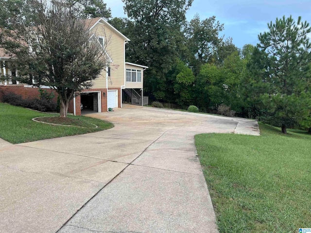 view of property exterior with a lawn and a garage