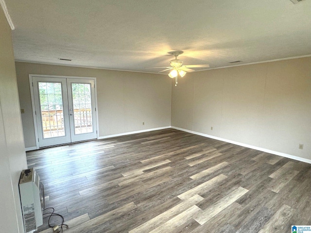 empty room with ceiling fan, ornamental molding, french doors, a textured ceiling, and dark wood-type flooring