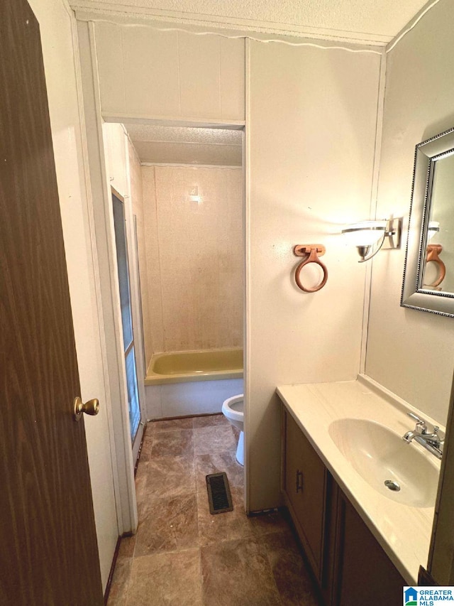 full bathroom with tile patterned floors, washtub / shower combination, vanity, and toilet