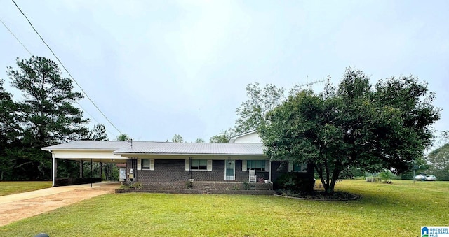 ranch-style house featuring a front lawn and a carport