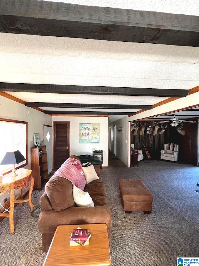 living room with dark colored carpet and beamed ceiling