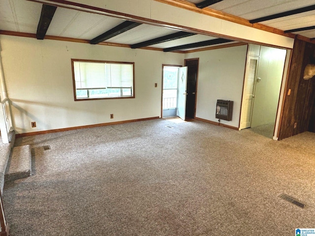 empty room featuring heating unit, beam ceiling, and carpet