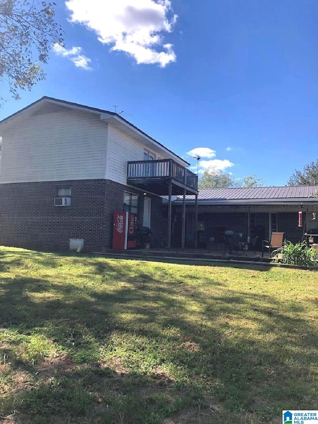 back of house with a deck and a lawn