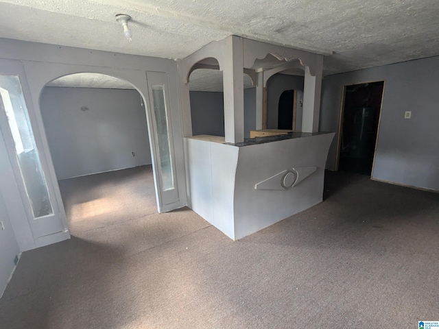 unfurnished room featuring a textured ceiling