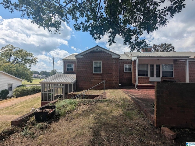 rear view of house with a sunroom and a patio area