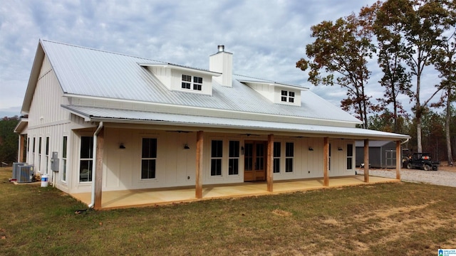 rear view of house featuring a lawn, a patio, central AC, ceiling fan, and a chimney