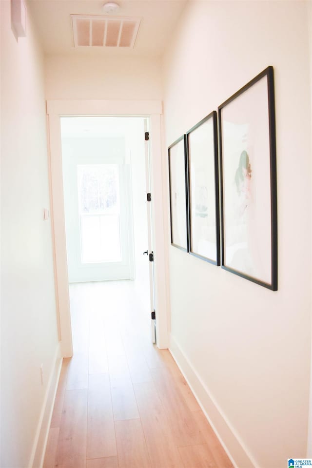 corridor with light wood-type flooring