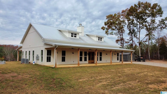 back of property featuring a patio, a yard, and central AC unit