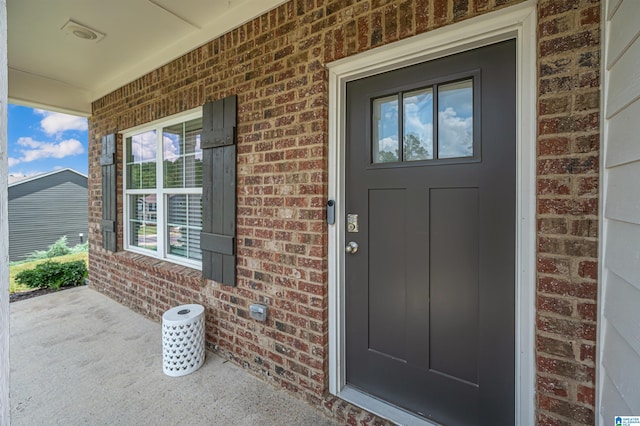 view of exterior entry featuring a porch