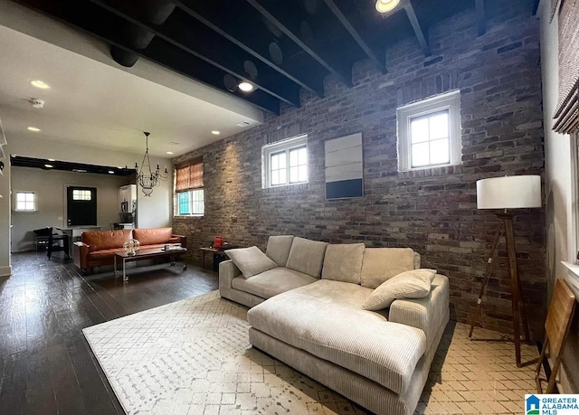 living area with brick wall, hardwood / wood-style floors, and recessed lighting