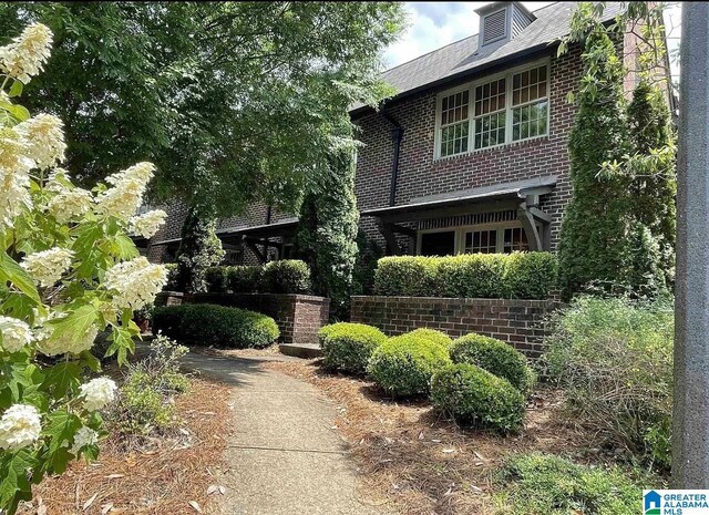 view of property exterior featuring brick siding
