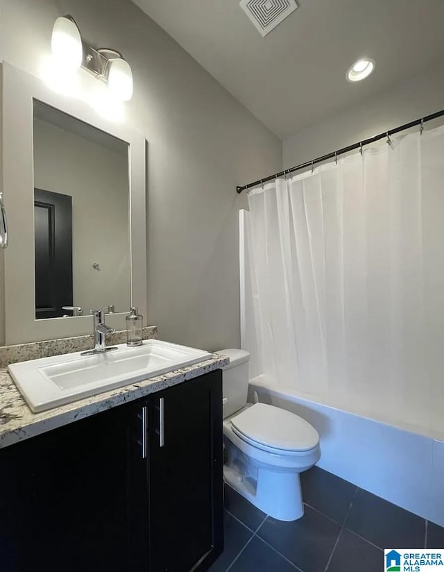 full bathroom with shower / tub combo with curtain, tile patterned floors, vanity, and toilet