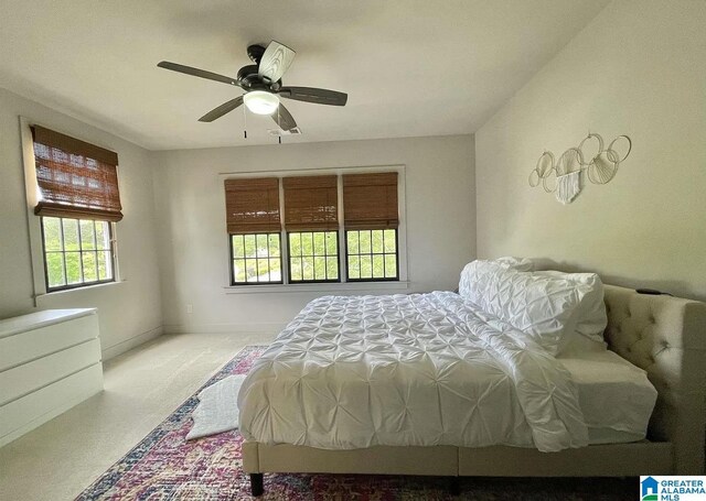 carpeted bedroom with a ceiling fan