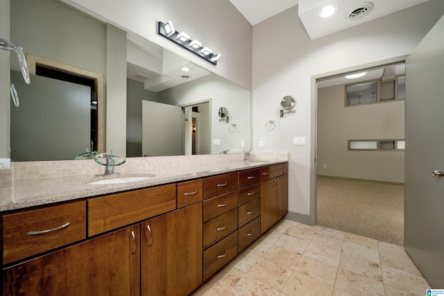 bathroom featuring vanity and backsplash