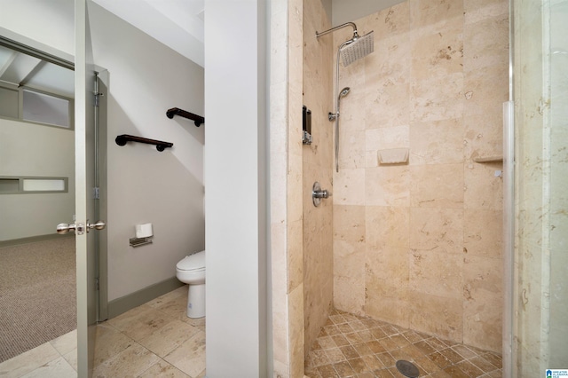 bathroom featuring toilet and a tile shower