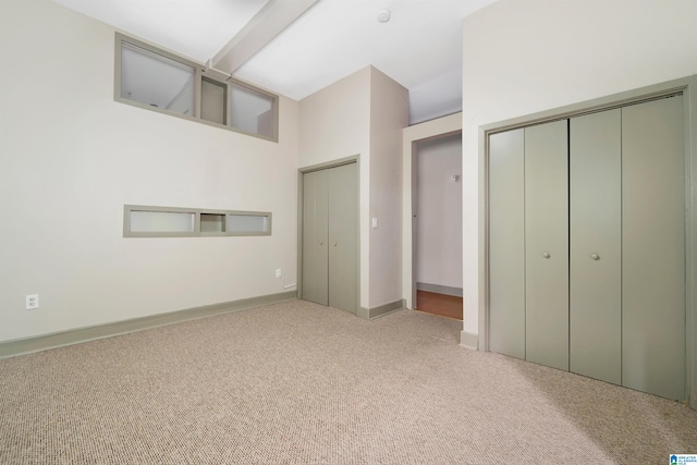 unfurnished bedroom featuring light carpet