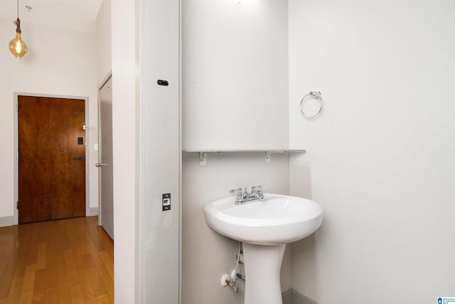 bathroom with hardwood / wood-style floors and sink