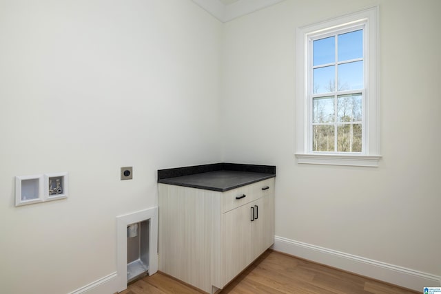 laundry area featuring cabinet space, light wood-style floors, baseboards, and hookup for an electric dryer