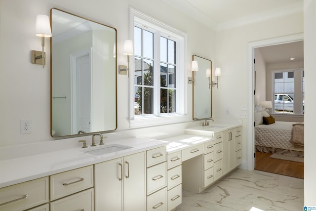 bathroom with a sink, plenty of natural light, and marble finish floor