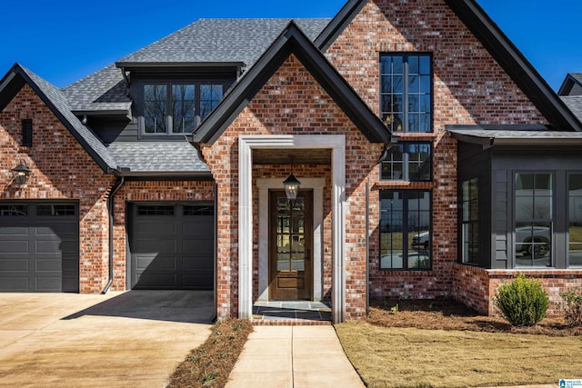 view of front of home with brick siding, concrete driveway, and a shingled roof