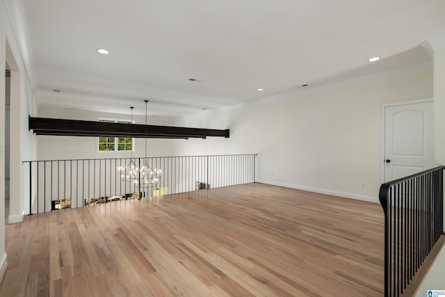 empty room with visible vents, baseboards, a chandelier, recessed lighting, and wood finished floors