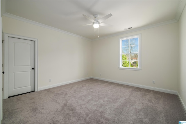 spare room featuring visible vents, ornamental molding, and carpet flooring