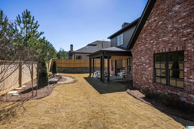 view of yard featuring a patio area and a fenced backyard