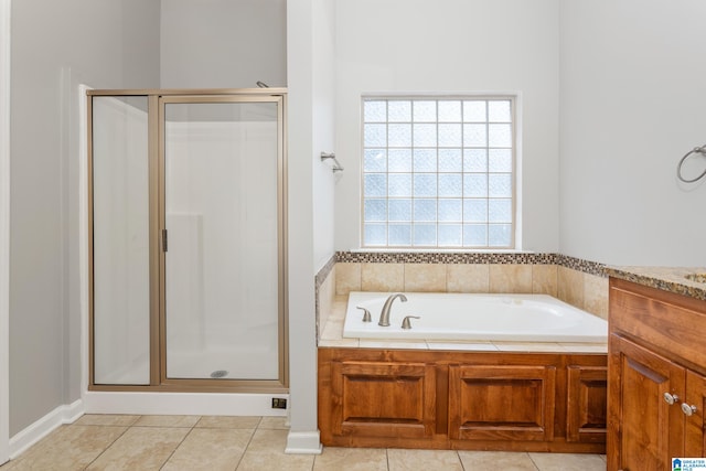 bathroom featuring shower with separate bathtub, tile patterned floors, and vanity