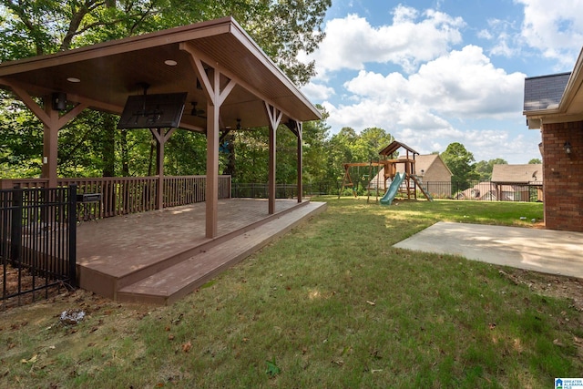 view of yard featuring a deck, a patio, a playground, and a gazebo