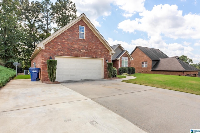 view of property featuring a garage and a front lawn