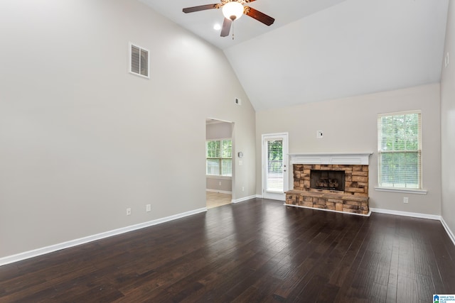 unfurnished living room featuring high vaulted ceiling, hardwood / wood-style floors, ceiling fan, and a fireplace