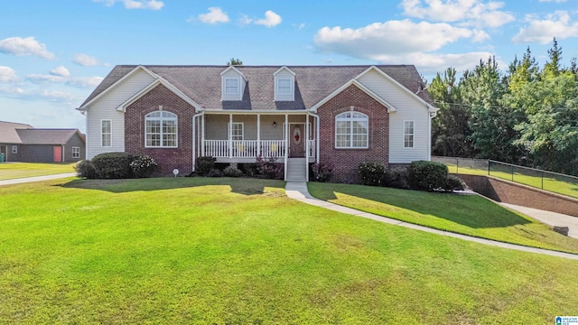 view of front of home with a front yard and covered porch