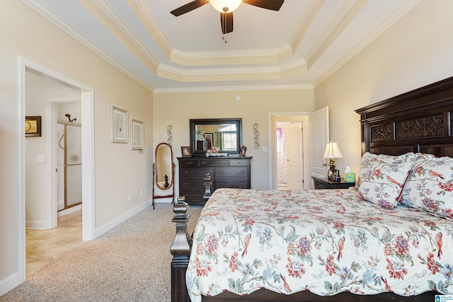 carpeted bedroom with ceiling fan, a raised ceiling, and crown molding