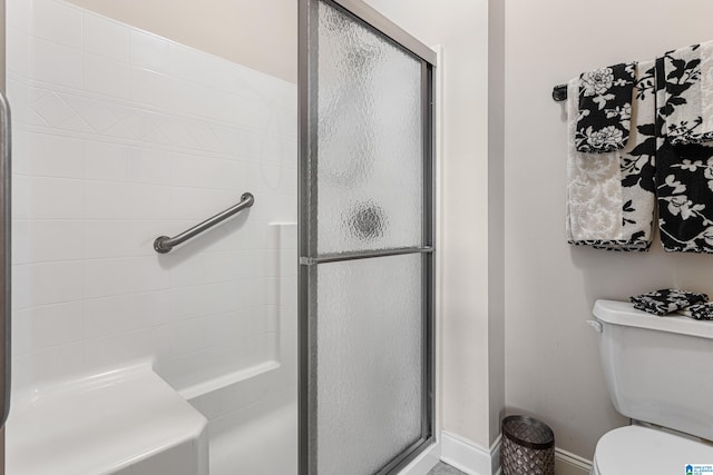 bathroom featuring walk in shower and toilet