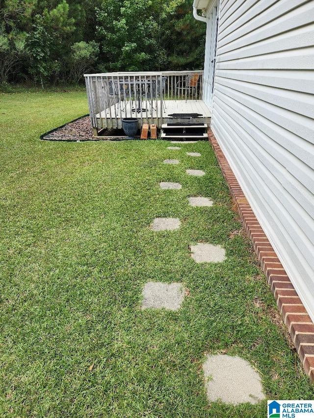 view of yard featuring a wooden deck