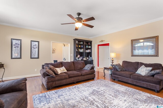 living room with light hardwood / wood-style floors, ornamental molding, and ceiling fan