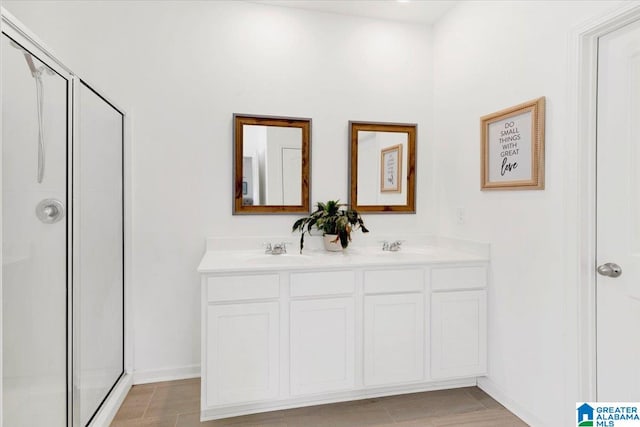 bathroom featuring vanity and an enclosed shower