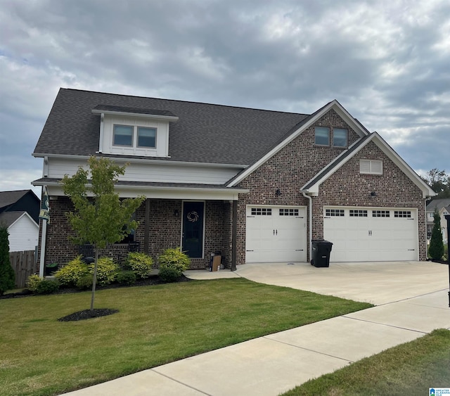 craftsman inspired home featuring a front yard and a garage