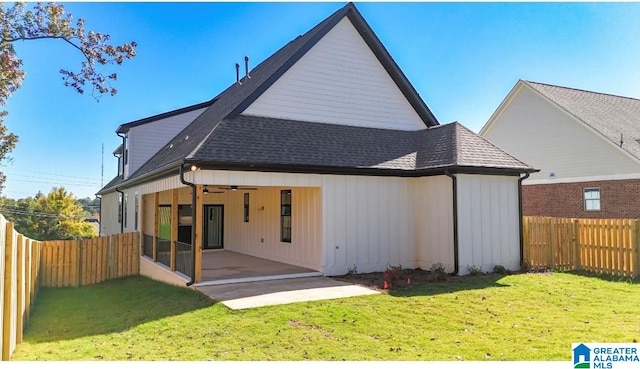 rear view of property with a patio, a yard, and ceiling fan