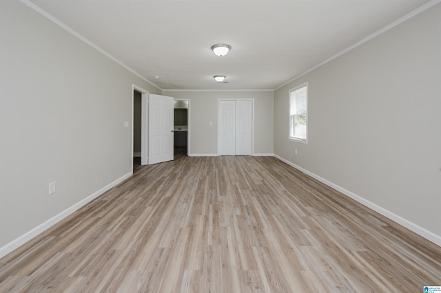 unfurnished bedroom with ornamental molding, light hardwood / wood-style flooring, and a closet