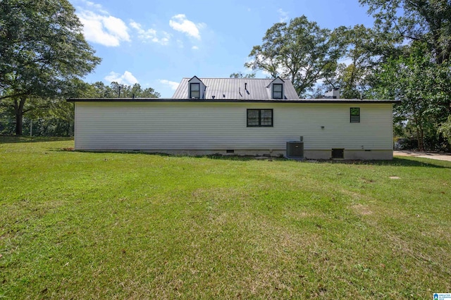 back of house with a lawn and central AC unit