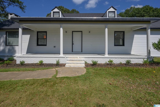 view of front of house with a front yard and covered porch