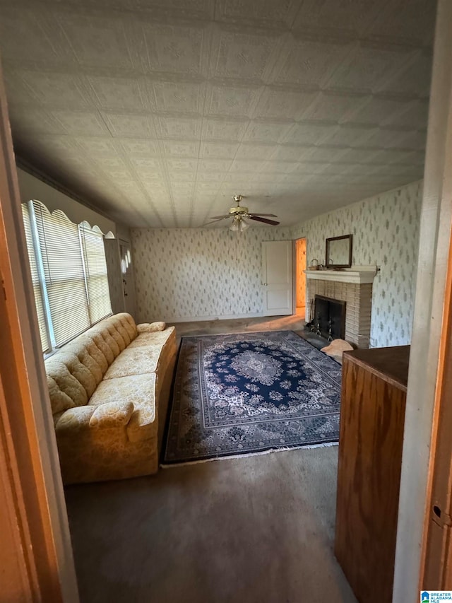 interior space featuring a tiled fireplace and ceiling fan