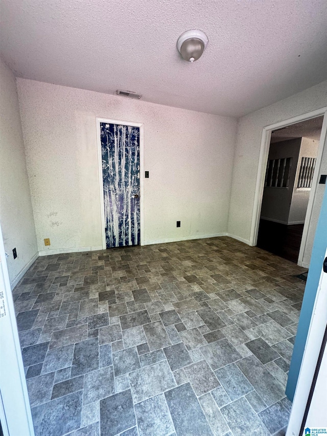 empty room featuring a textured ceiling