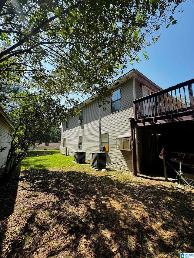 view of yard featuring cooling unit and a wooden deck