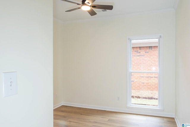 empty room featuring crown molding, ceiling fan, and light wood-type flooring