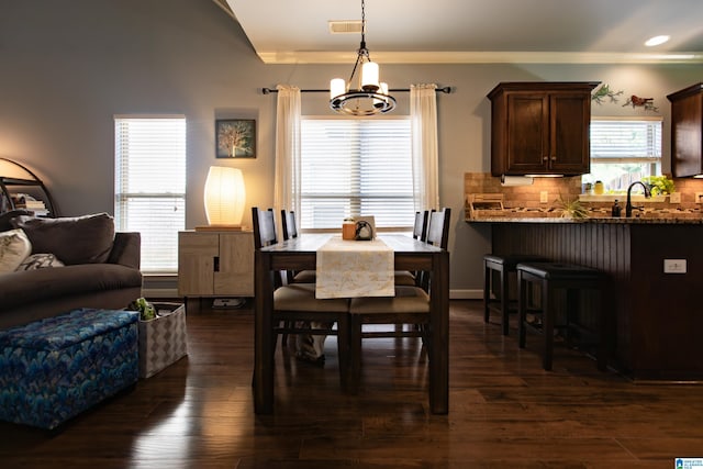 dining space with a notable chandelier and dark hardwood / wood-style flooring